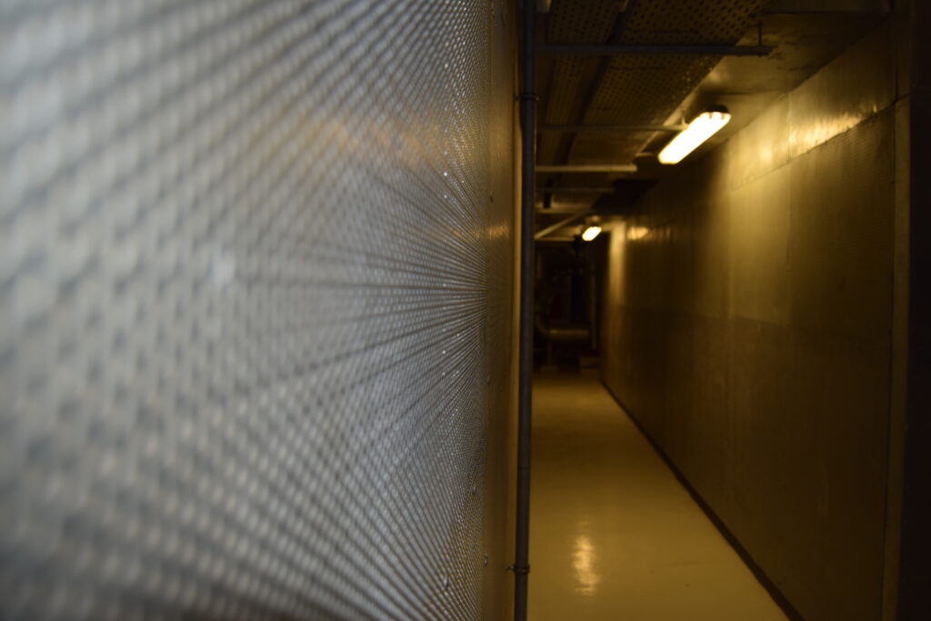 Acoustic absorbent panels installed on the wall of a substation facility.