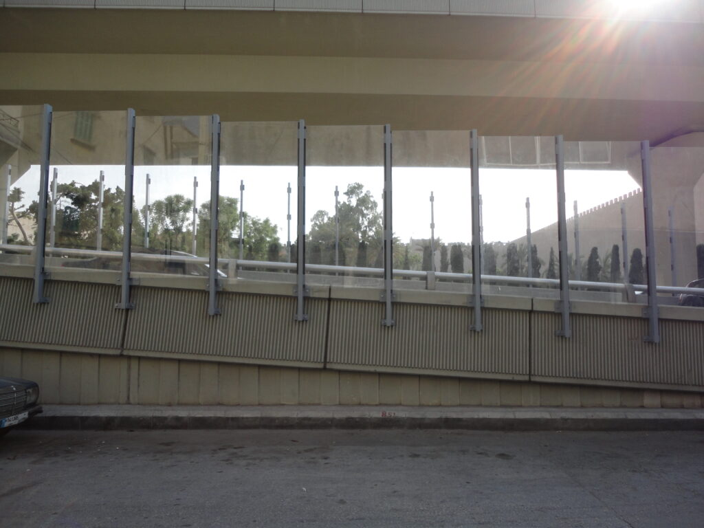 Side view of an acoustic sound barrier installed for industrial noise control.