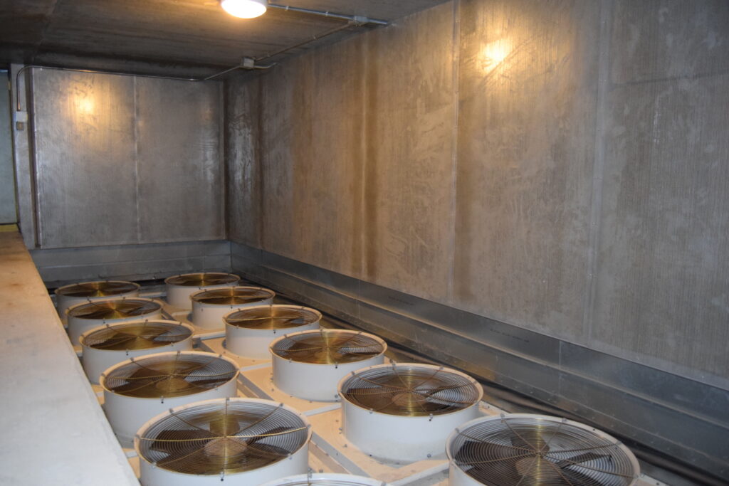 Acoustic absorbent panels installed on walls of a Box-in-Box generator room.