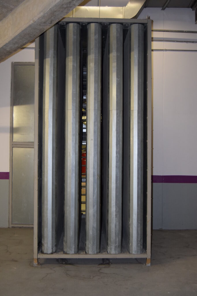 Sound attenuator integrated in a chiller acoustic enclosure for HVAC noise control.