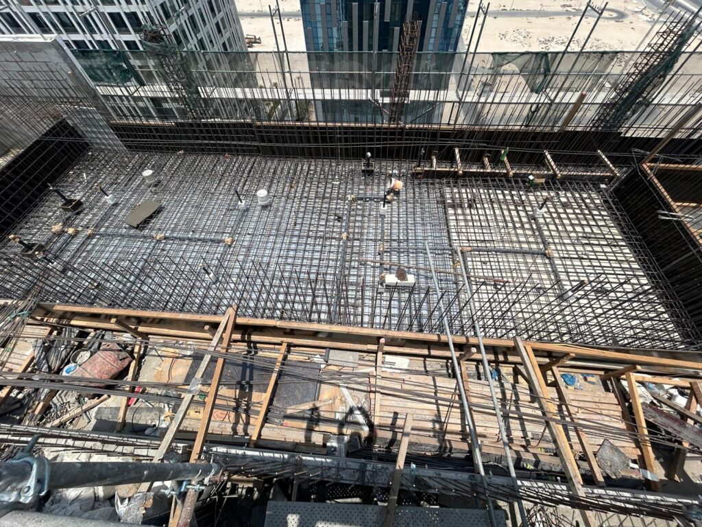 Completed floating swimming pool installed above residential units in a tower.