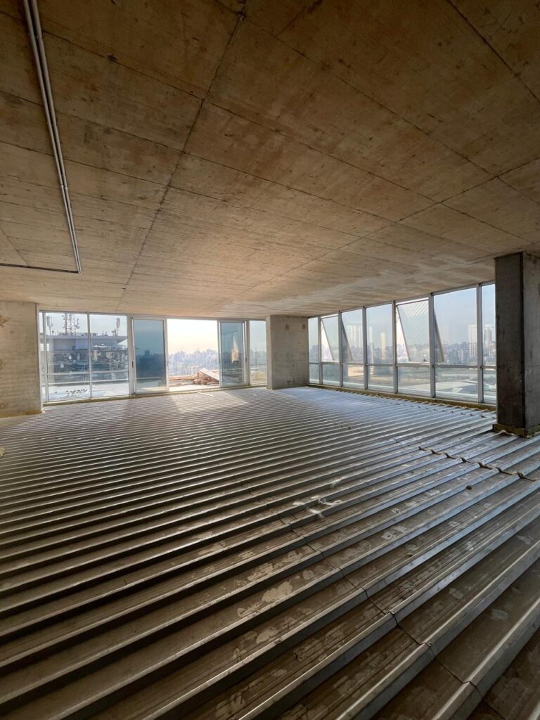 Completed floating floor system isolating gym noise above office spaces.